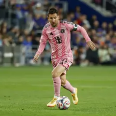 Lionel Messi w różowej koszulce Inter Miami drybluje piłką na boisku MLS.