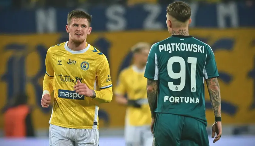 Piłkarze na boisku podczas meczu na Arena Lublin dzisiaj. Jeden w żółtej koszulce, drugi w zielonej z numerem 91.